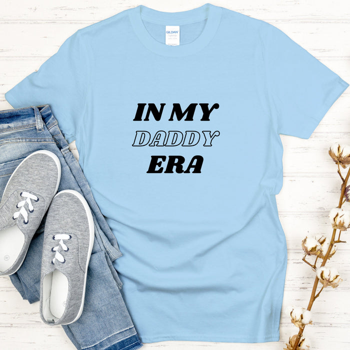 a t - shirt that says in my daddy era next to a pair of jeans