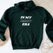 a green hoodie that says in my daddy era