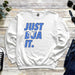 a white sweatshirt that says just dua it