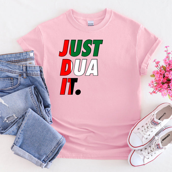 a pink t - shirt that says just dua it next to a pair of