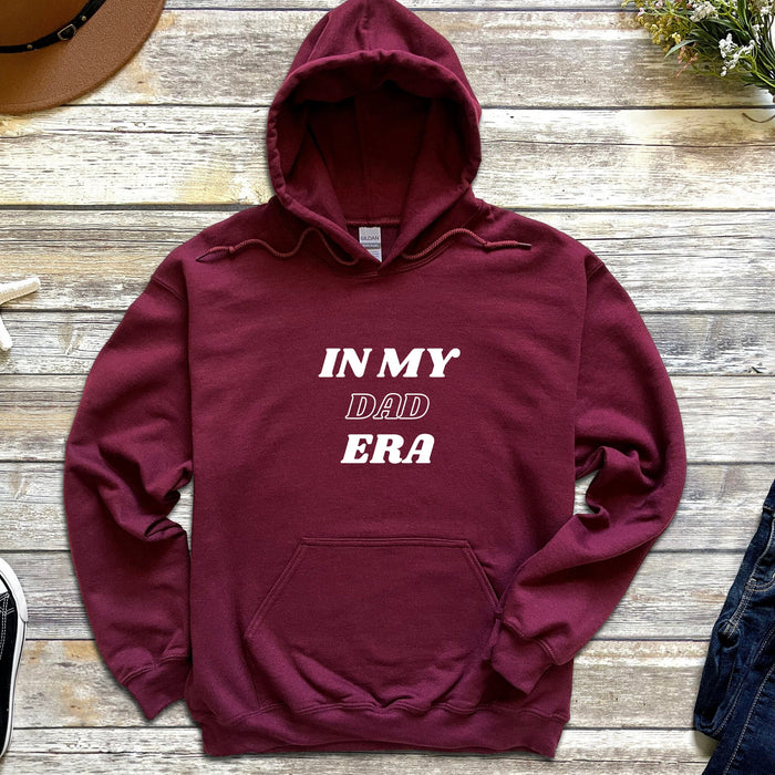 a maroon hoodie that says in my dad era