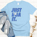 a t - shirt that says just dua it next to a pair of jeans